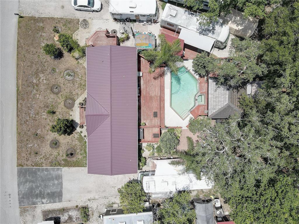 An aerial view shows a house with a purple roof, a pool, and several RVs — 9501 ESTELLE STREET, NEW PORT RICHEY, FL