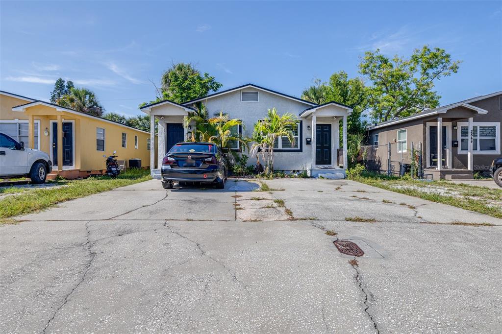 A single-story duplex with a shared concrete driveway and two separate front entrances — 2834 & 2836 FREEMONT TERRACE S, ST PETERSBURG, FL
