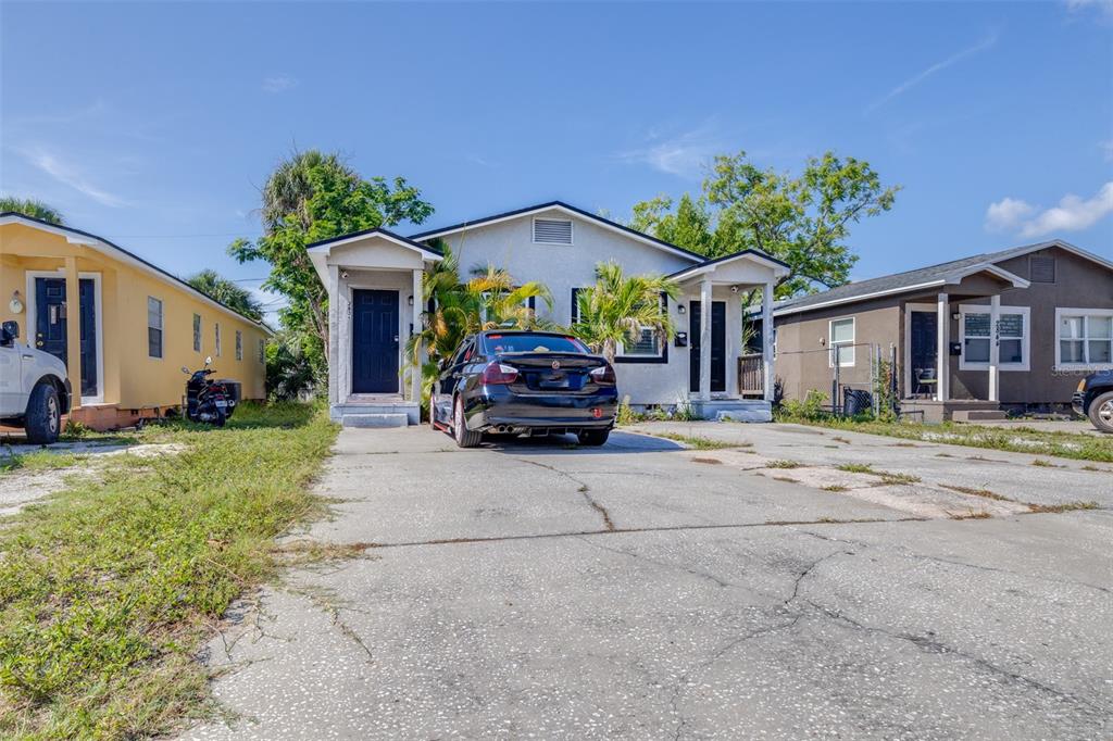 A single-story house with a concrete driveway and a black sedan parked in front — 2834 & 2836 FREEMONT TERRACE S, ST PETERSBURG, FL