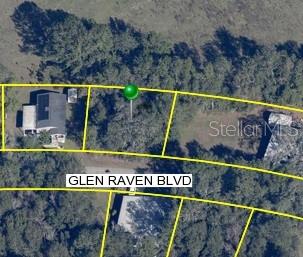 This is an aerial map showing a vacant residential lot between two existing homes — 18035 GLEN RAVEN BOULEVARD, BROOKSVILLE, FL