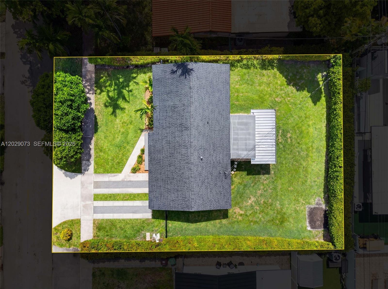 An aerial view shows a house with a gray roof, a driveway, and a fenced yard — 680 W 50th Pl, Hialeah FL 33012, HIALEAH, FL