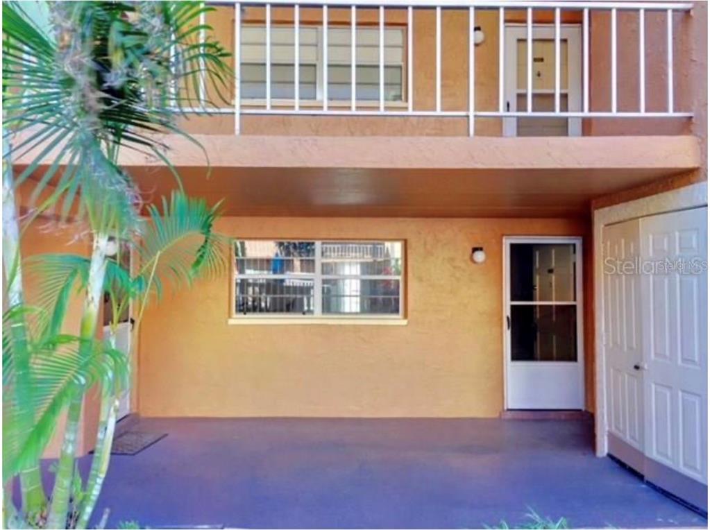 A covered patio area with a window, a door, and a storage closet — 12760 INDIAN ROCKS ROAD UNIT 1024, LARGO, FL