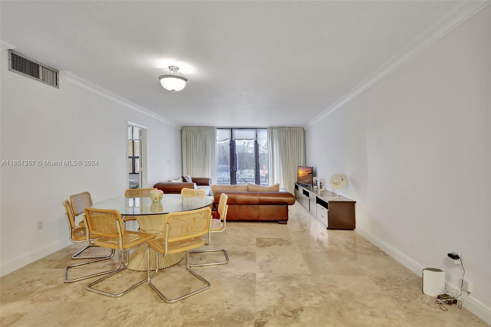 A living and dining area features tile flooring, a glass-topped table, and leather furniture — 9801 Collins Ave # 3T, Bal Harbour FL 33154, BAL HARBOUR, FL