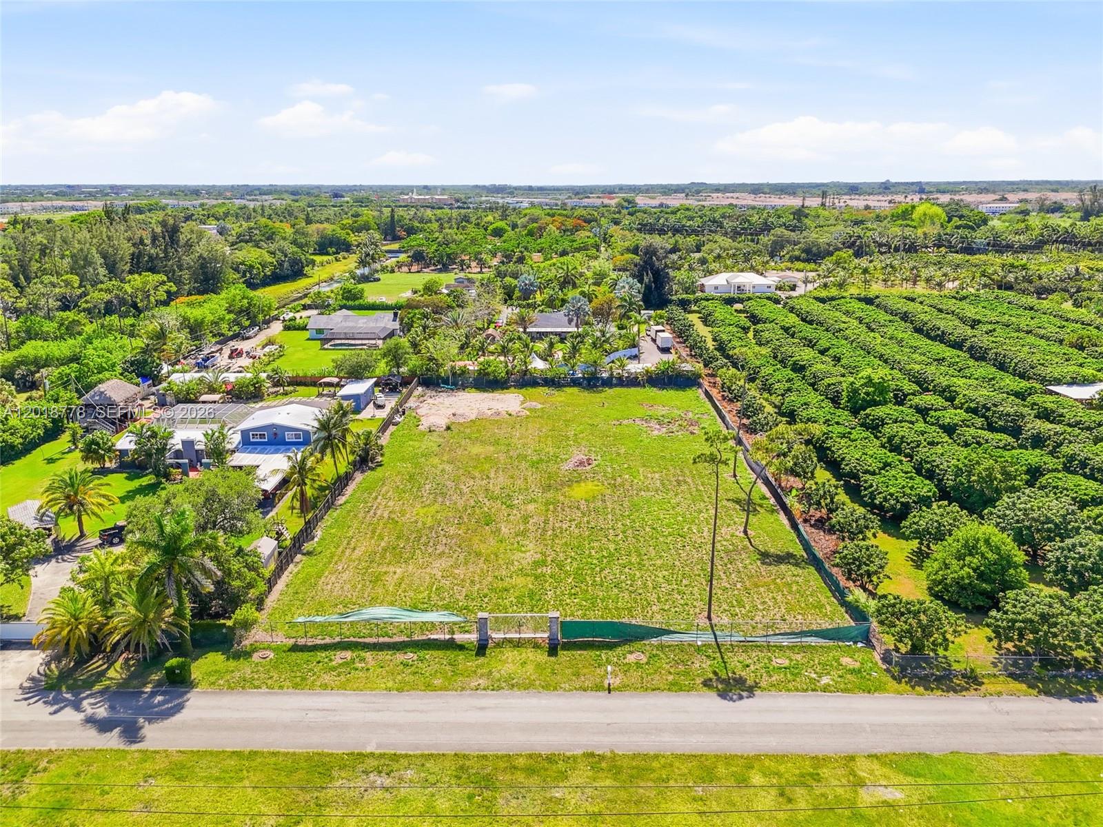An aerial view shows a rectangular vacant lot bordered by a road, trees, and houses — 23600 SW 122 AVE, Miami FL 33032, MIAMI, FL