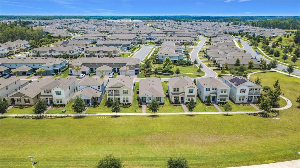 An aerial view shows a suburban neighborhood with rows of houses and a large lawn — 11117 BOSTWICK ALLEY, WINTER GARDEN, FL