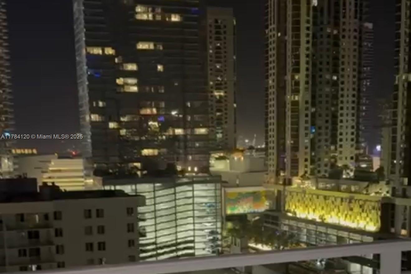 A night view of illuminated high-rise buildings seen from a balcony — 850 N Miami Ave # 2101, Miami FL 33136, MIAMI, FL