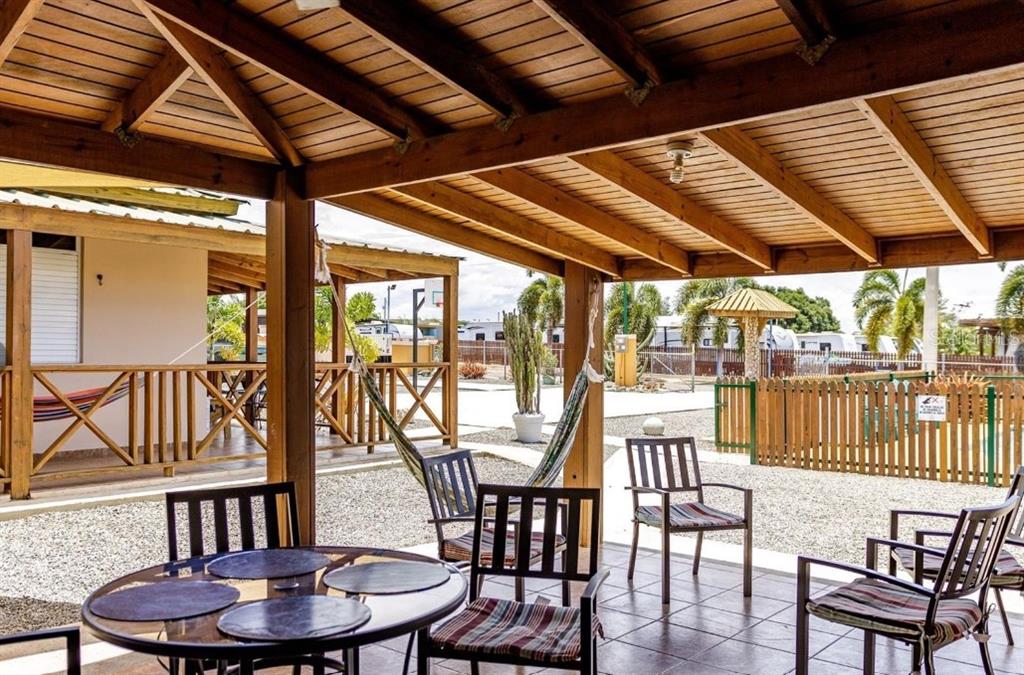 A covered outdoor patio features a dining table, chairs, a hammock, and a wooden ceiling — B-13 CARR 3301 KM HM 1.9 INT STREET UNIT B-13, CABO ROJO, PR