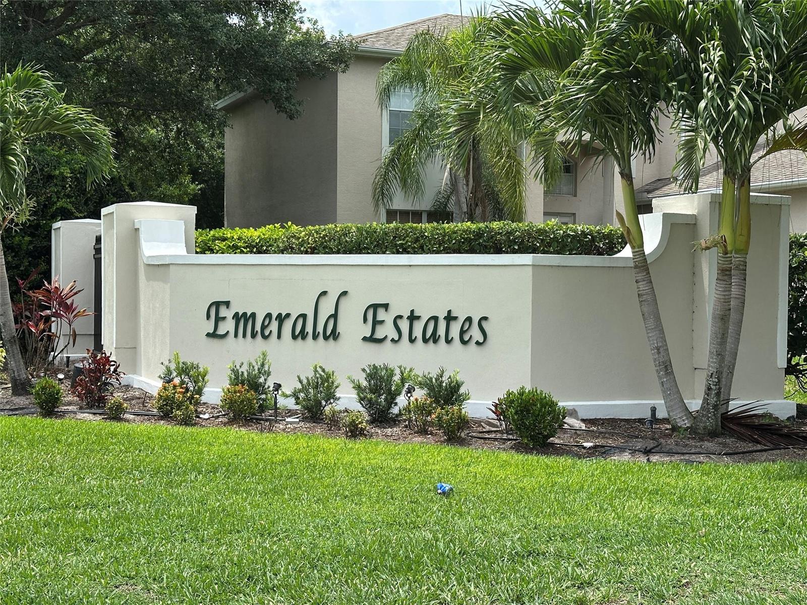 A beige stucco sign for Emerald Estates stands in front of a residential building — 6075 46th Lane, Vero Beach FL 32967, VERO BEACH, FL