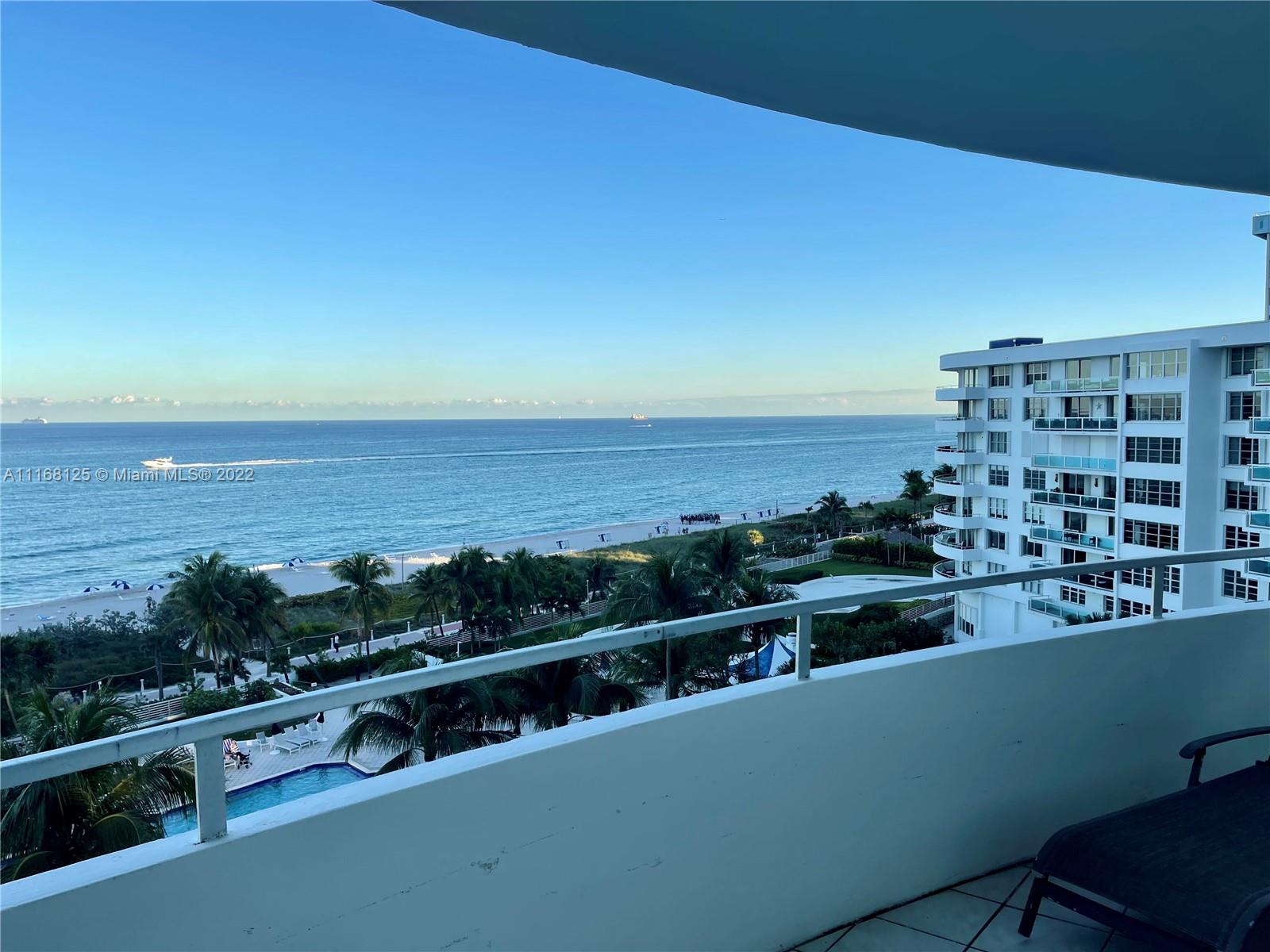 A balcony overlooks a swimming pool, palm trees, a sandy beach, and the ocean — 5161 Collins Ave # 914, Miami Beach FL 33140, MIAMI BEACH, FL