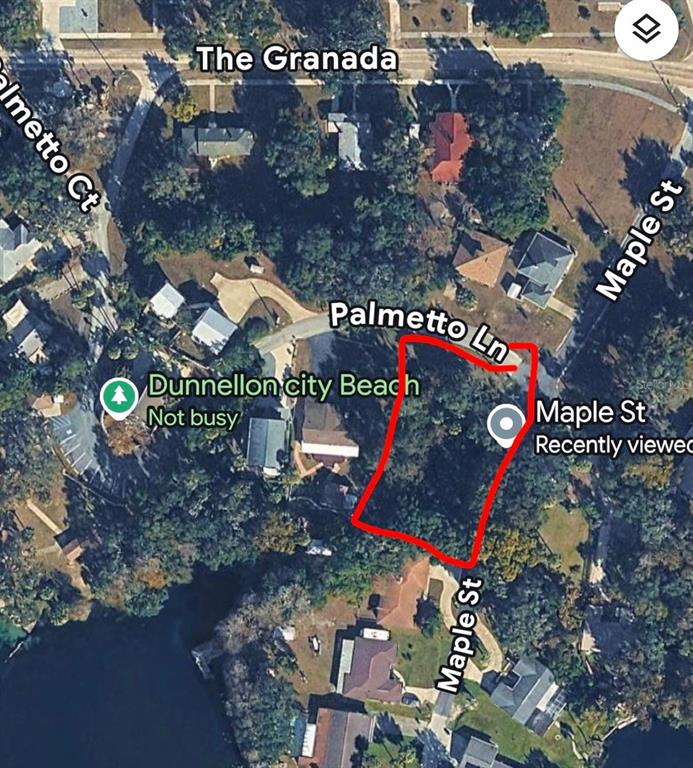 An aerial map view shows a vacant, wooded lot outlined in red near a city beach — MAPLE STREET, DUNNELLON, FL