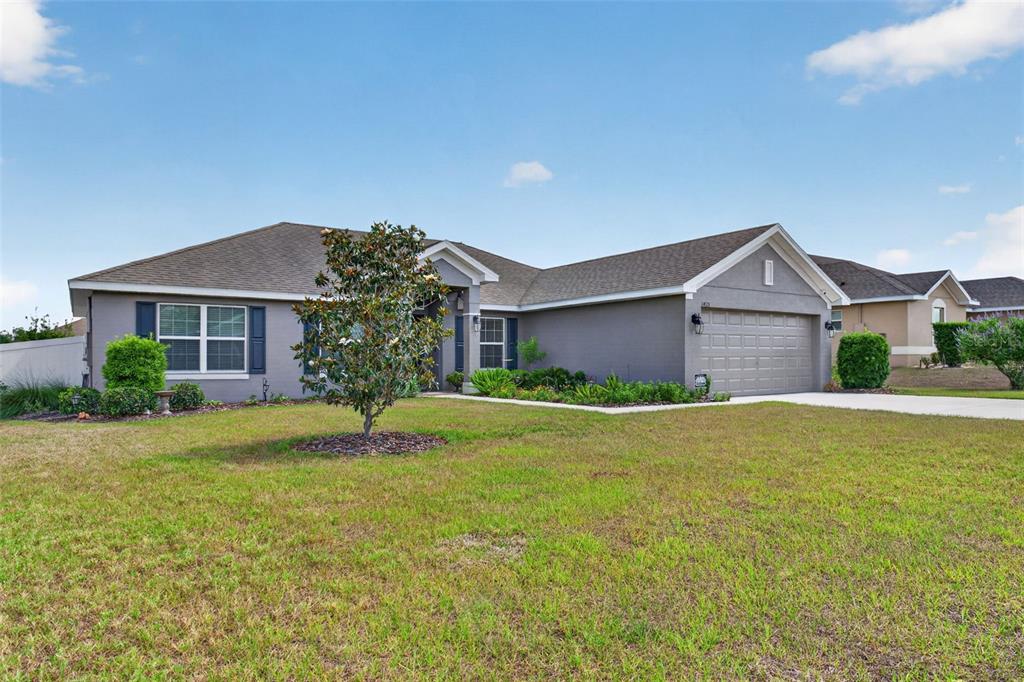 A single-story gray house with a two-car garage and a front lawn — 2429 TWIN LAKE VIEW ROAD, WINTER HAVEN, FL
