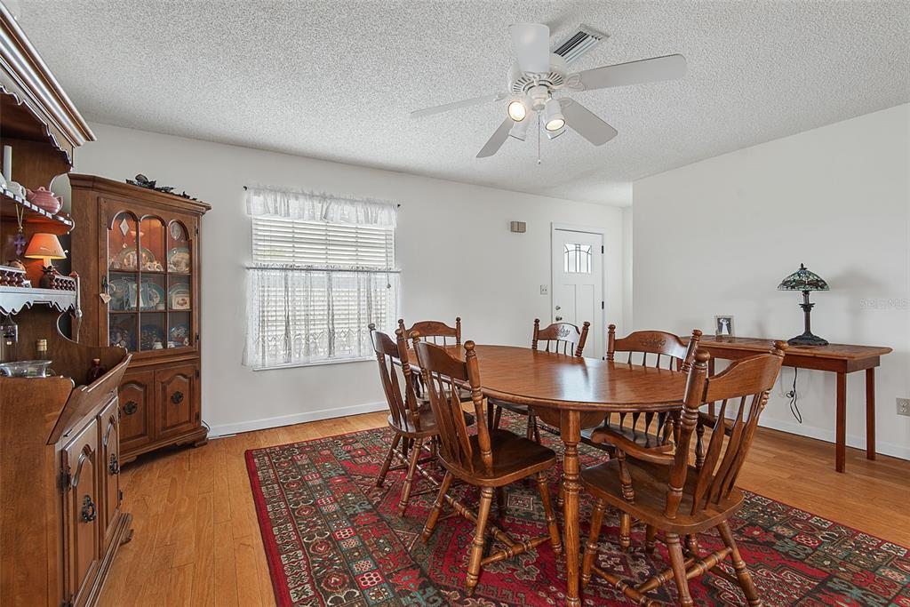 A dining room features a wooden table and chairs on a patterned rug — 309 CYPRESS STREET, FLAGLER BEACH, FL
