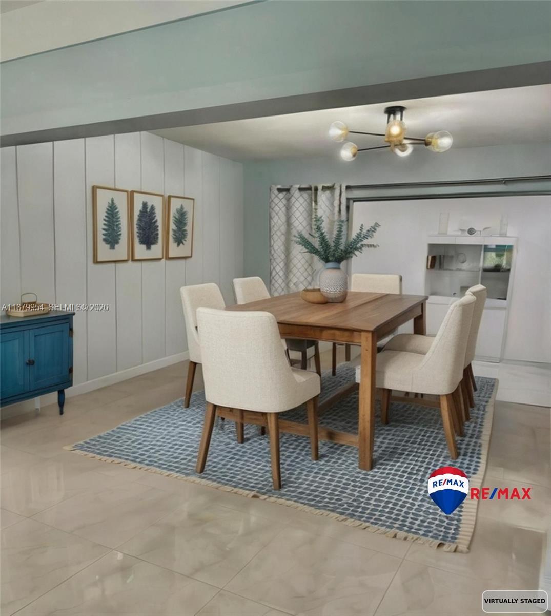 A dining room features a wooden table, six upholstered chairs, and a blue area rug — 4713 Holly Dr, Tamarac FL 33319, TAMARAC, FL