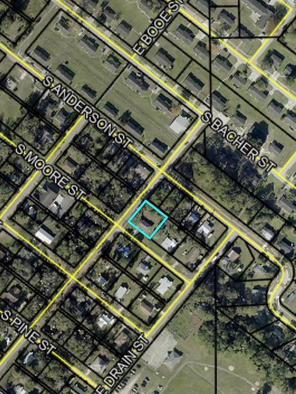This is an aerial map showing a residential property highlighted in blue — XXXX S MOORE STREET, BUNNELL, FL
