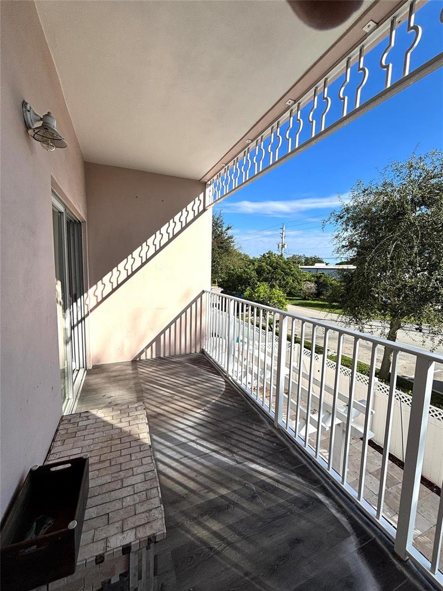 A balcony with a white metal railing, decorative trim, and a brick-topped planter — 451 NE 1st Street # 451, Pompano Beach FL 33060, POMPANO BEACH, FL