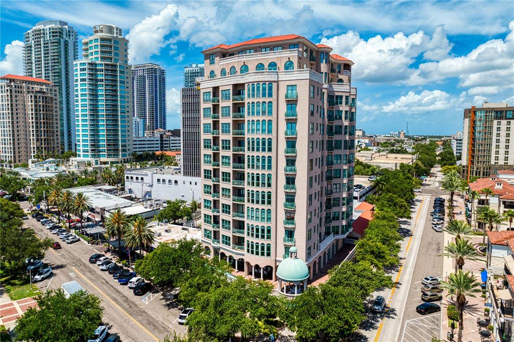 An aerial view of a multi-story tan residential building with a green domed entrance — 288 BEACH DRIVE NE UNIT PH-2A, ST PETERSBURG, FL