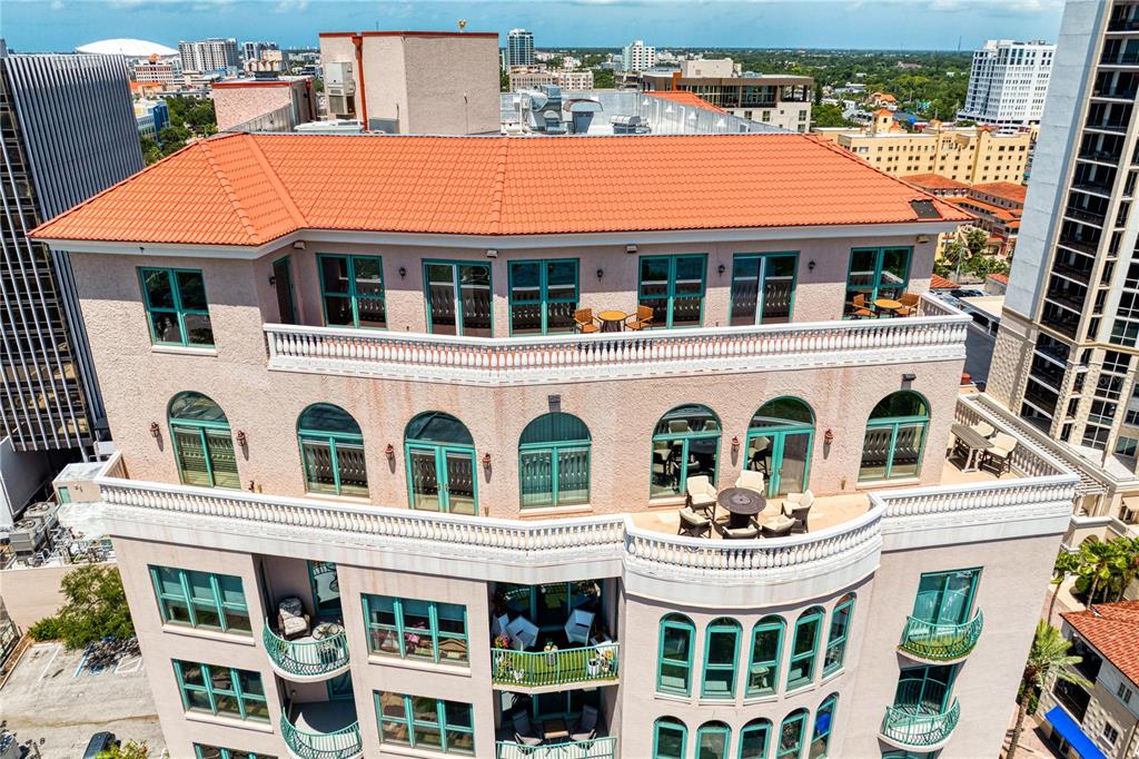 An aerial view of a multi-story building featuring balconies, arched windows, and a tiled roof — 288 BEACH DRIVE NE UNIT PH-2A, ST PETERSBURG, FL