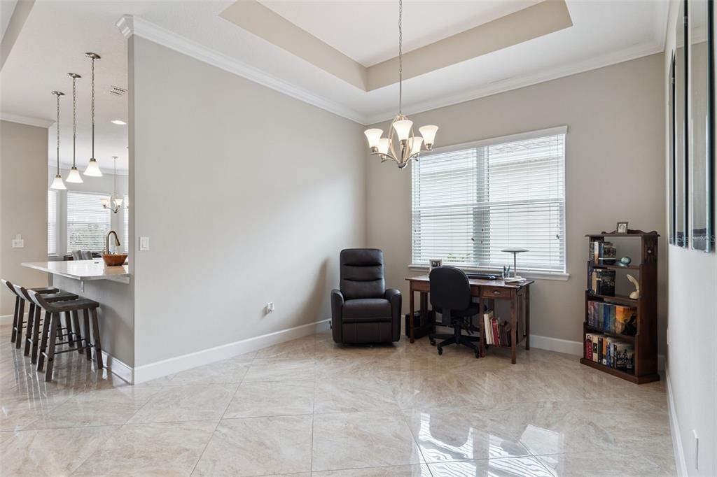 A room with tile flooring, a desk, a recliner, and a bookshelf near a window — 1365 BRAYFORD POINT, DELAND, FL