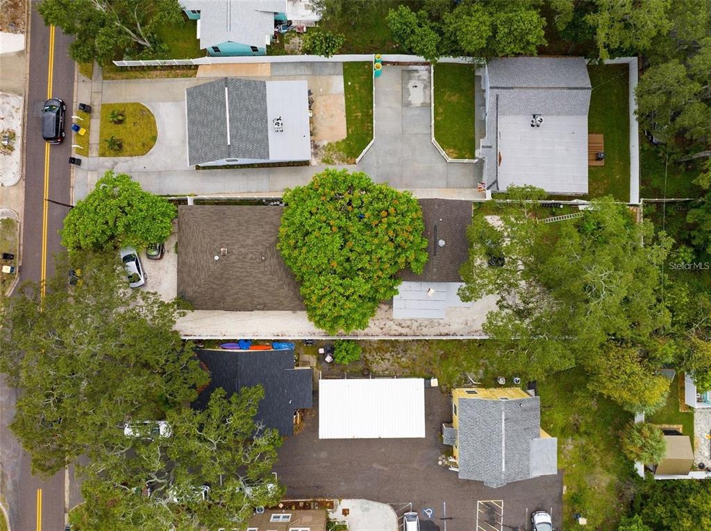 An aerial view shows several residential buildings with driveways, trees, and parking areas — 912 DRUID ROAD E, CLEARWATER, FL
