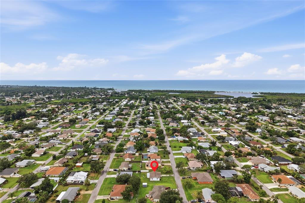 An aerial view shows a residential neighborhood with a red marker on a house — 935 EVEREST ROAD, VENICE, FL