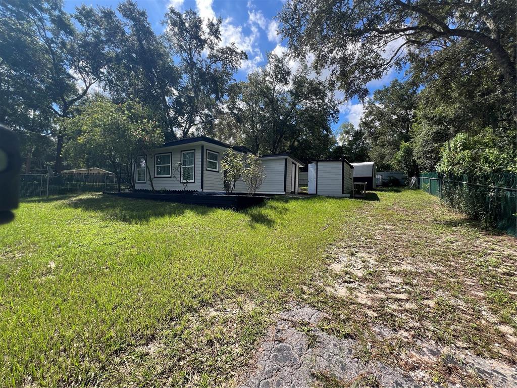 A single-story house with white siding and dark trim sits on a grassy lot — 3750 HILLTOP, DUNNELLON, FL