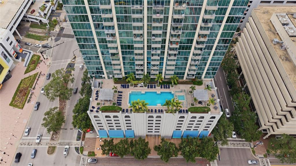An aerial view shows a high-rise building with a rooftop pool and parking garage — 777 N ASHLEY DRIVE UNIT 2613, TAMPA, FL