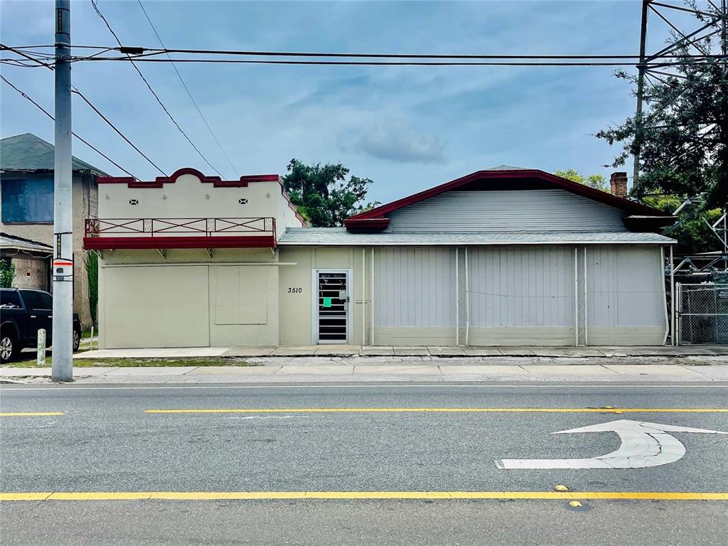 A single-story commercial building with a beige facade and a metal-covered front entrance — 3510 N NEBRASKA AVENUE, TAMPA, FL