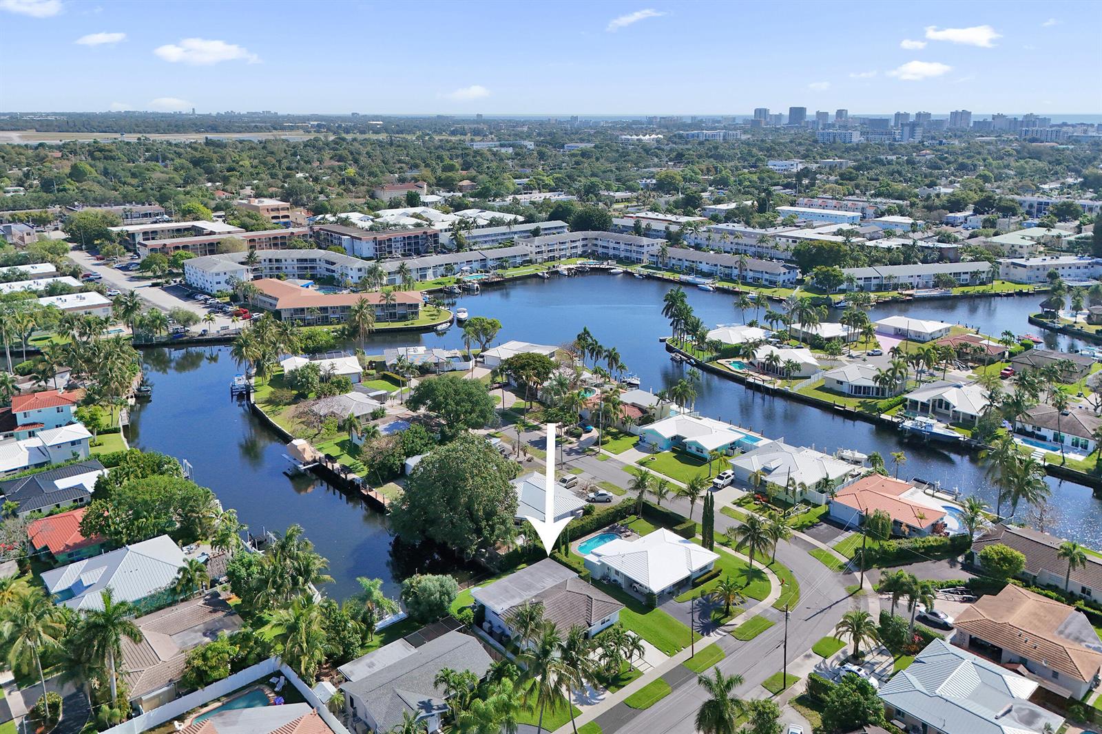 An aerial view shows a residential neighborhood with houses, swimming pools, and a central canal — 381 SE 3rd Street, Pompano Beach FL 33060, POMPANO BEACH, FL