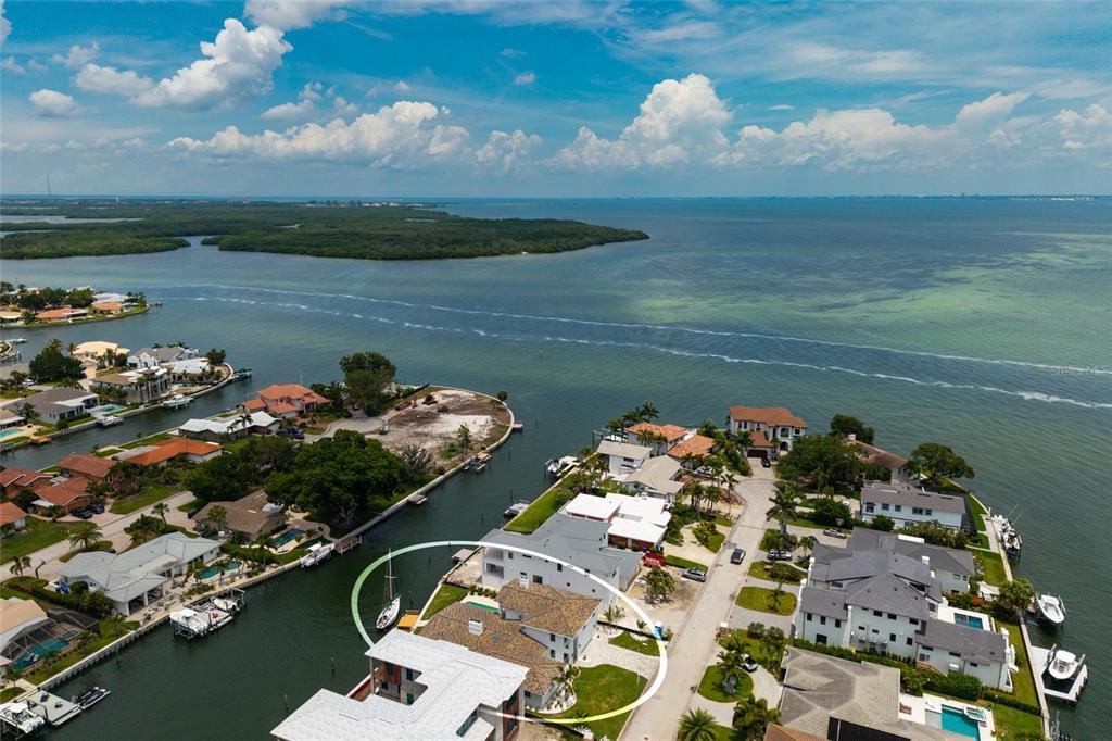 An aerial view shows a waterfront house with a boat dock on a canal — 2063 ILLINOIS AVENUE NE, ST PETERSBURG, FL