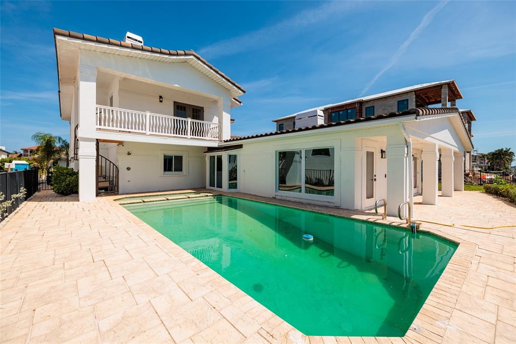 A white two-story house with a swimming pool and a paved patio area — 2063 ILLINOIS AVENUE NE, ST PETERSBURG, FL