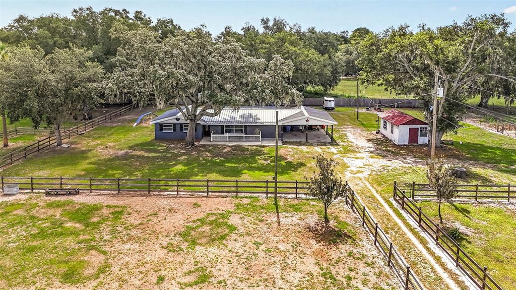 An aerial view shows a single-story house with a metal roof and a detached shed — 5702 TINDALE ROAD, PLANT CITY, FL