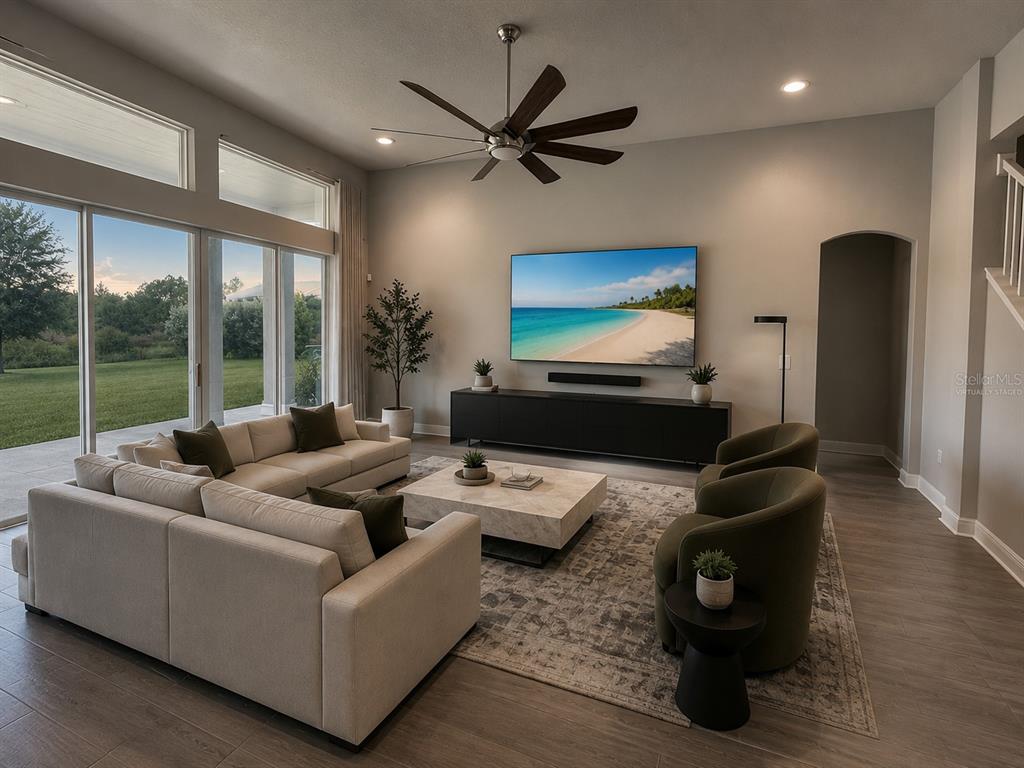 A modern kitchen features gray cabinets, white countertops, and a blue honeycomb tile backsplash — 3275 TOUR TRACE, LAND O LAKES, FL