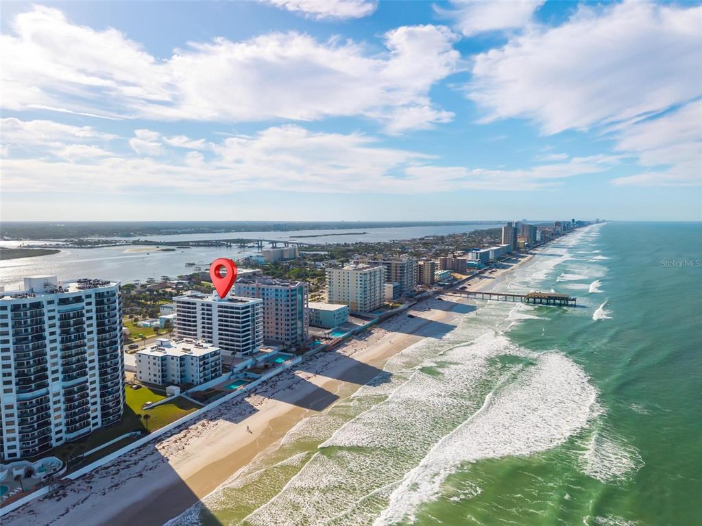 An aerial view shows a beachfront condominium building with a red location pin — 3743 S ATLANTIC AVENUE UNIT 7A00, DAYTONA BEACH, FL