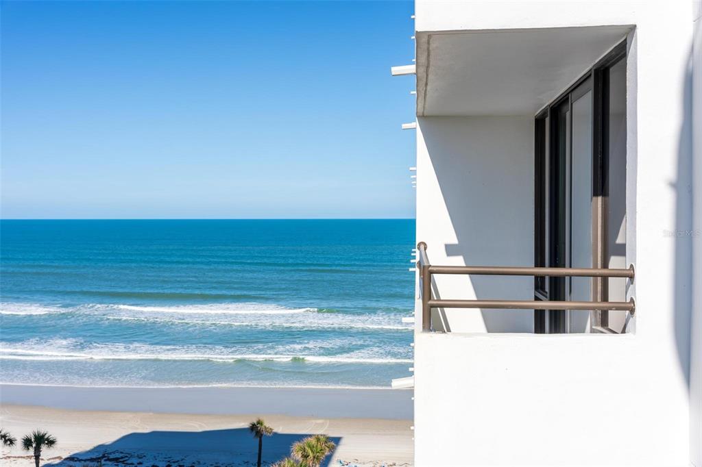 A view of the ocean and beach from a white balcony with a metal railing — 3743 S ATLANTIC AVENUE UNIT 7A00, DAYTONA BEACH, FL