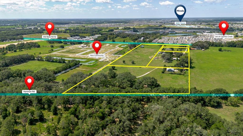 This aerial map shows a large, undeveloped plot of land outlined in yellow — 31668 HARTMAN ROAD, SAN ANTONIO, FL