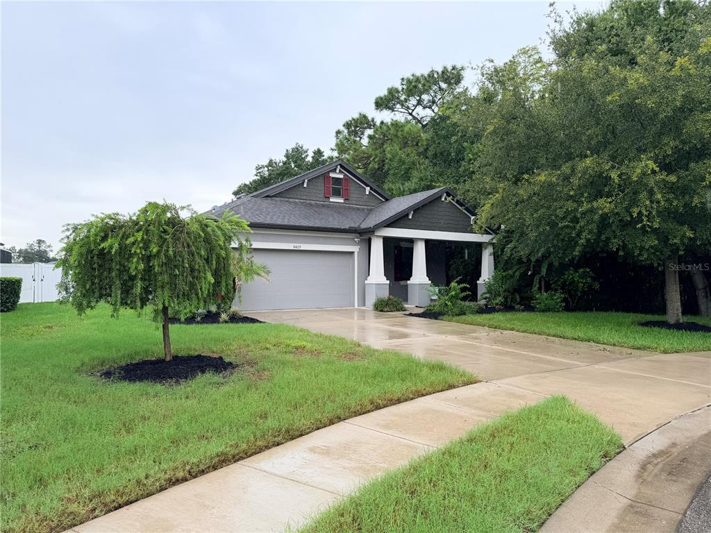 A screened-in swimming pool with a water feature and a paver deck — 8429 AUBURN RISE COURT, LAND O LAKES, FL
