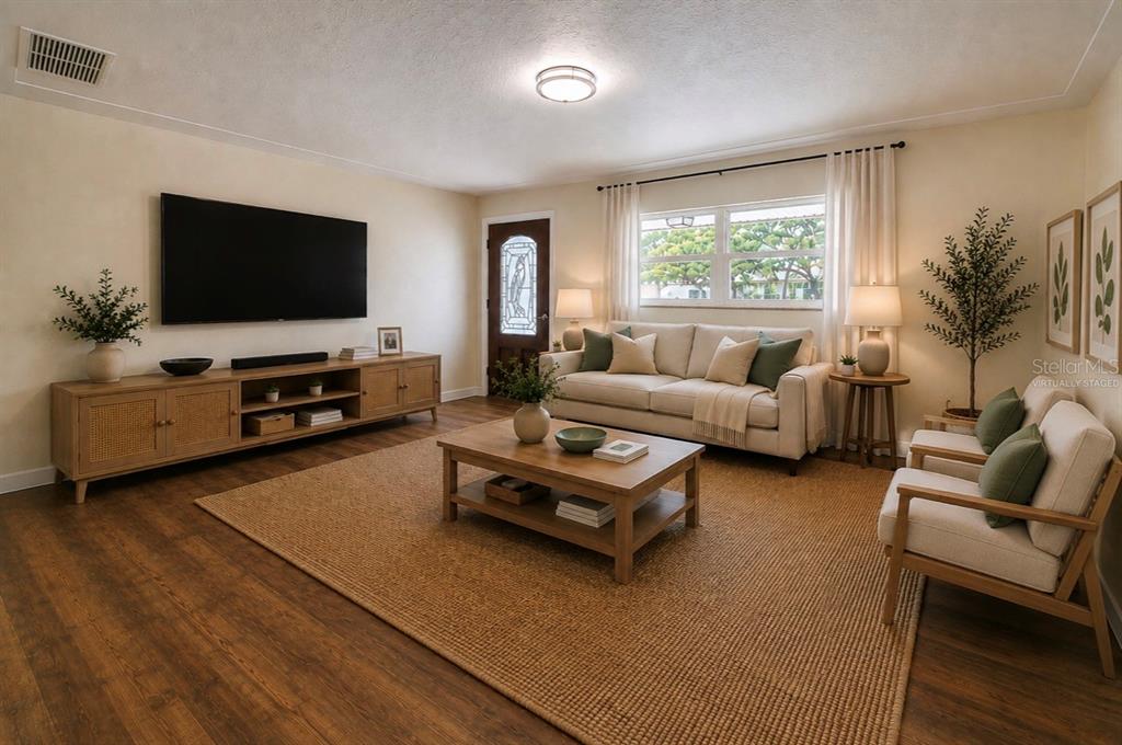A living room features a sofa, two armchairs, a television, and a wooden coffee table — 5546 113TH STREET, SEMINOLE, FL