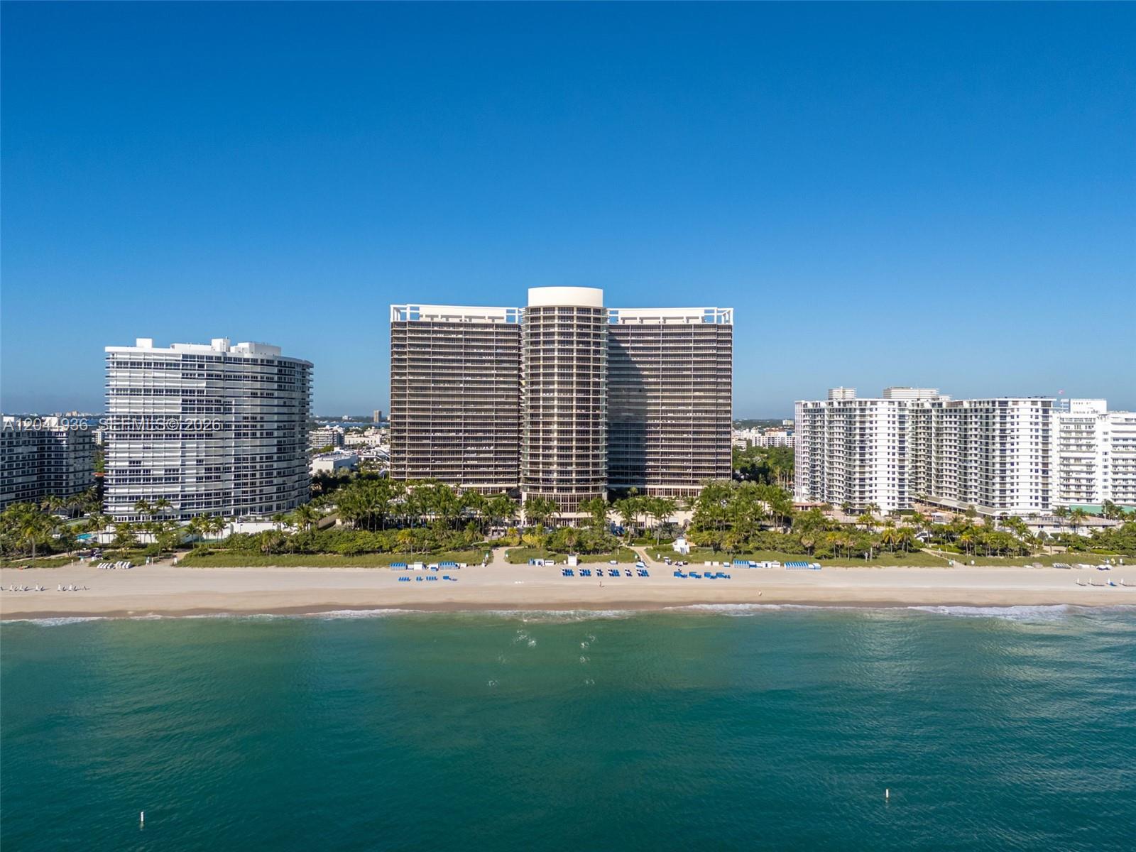An aerial view shows three large residential buildings situated along a sandy beach — 9705 Collins Ave # 1402N, Bal Harbour FL 33154, BAL HARBOUR, FL