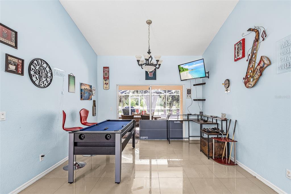 A game room features a pool table, a ping pong table, and light blue walls — 2590 ABBOTSFORD STREET, NORTH PORT, FL