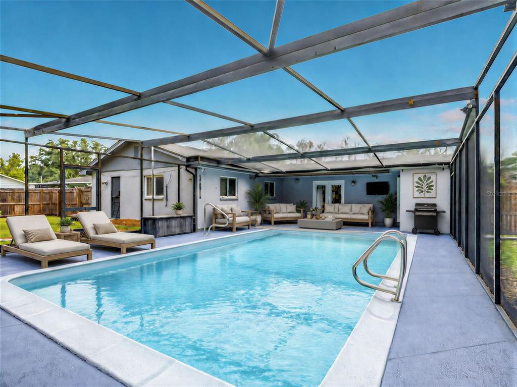 A swimming pool with a screened-in enclosure, patio furniture, and a grill on the deck — 1231 NEWPORT AVENUE, LAKELAND, FL