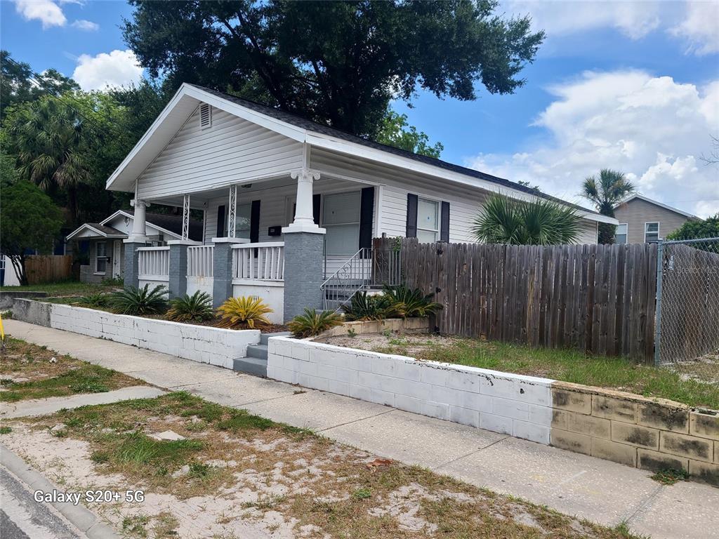 A white house with a front porch and a low concrete block retaining wall — 2220 E 17TH AVENUE, TAMPA, FL