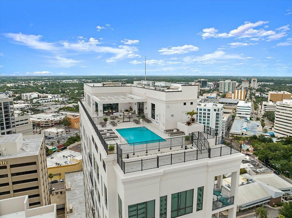 An aerial view of a rooftop swimming pool and patio area on a high-rise building — 33 S PALM AVENUE UNIT 901, SARASOTA, FL
