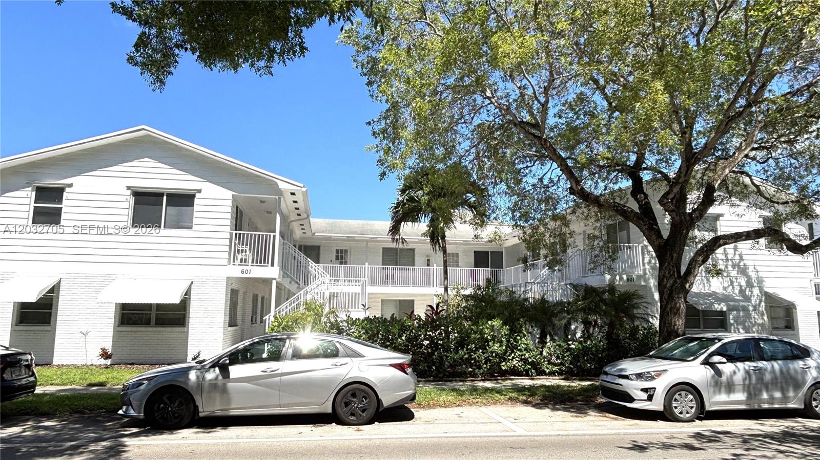 A two-story white apartment building with exterior staircases and parked cars in front — 601 S 19th Ave # 10, Hollywood FL 33020, HOLLYWOOD, FL