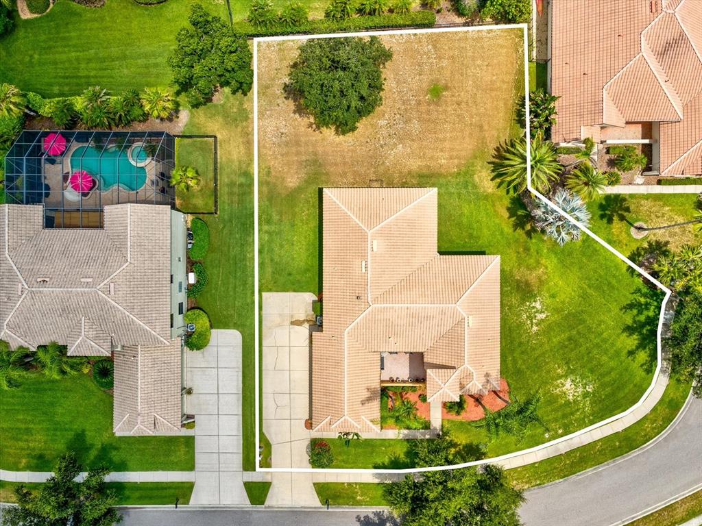 An aerial view shows a house with a tiled roof and a large, fenced backyard — 3708 MARBURY COURT, LAND O LAKES, FL