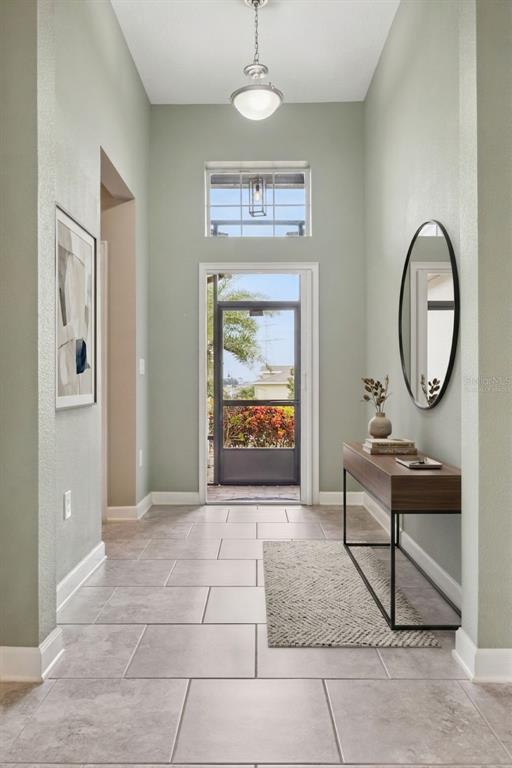 A kitchen features white cabinets, granite countertops, a tiled backsplash, and a breakfast bar island — 3464 EMBERS LANE, CLERMONT, FL