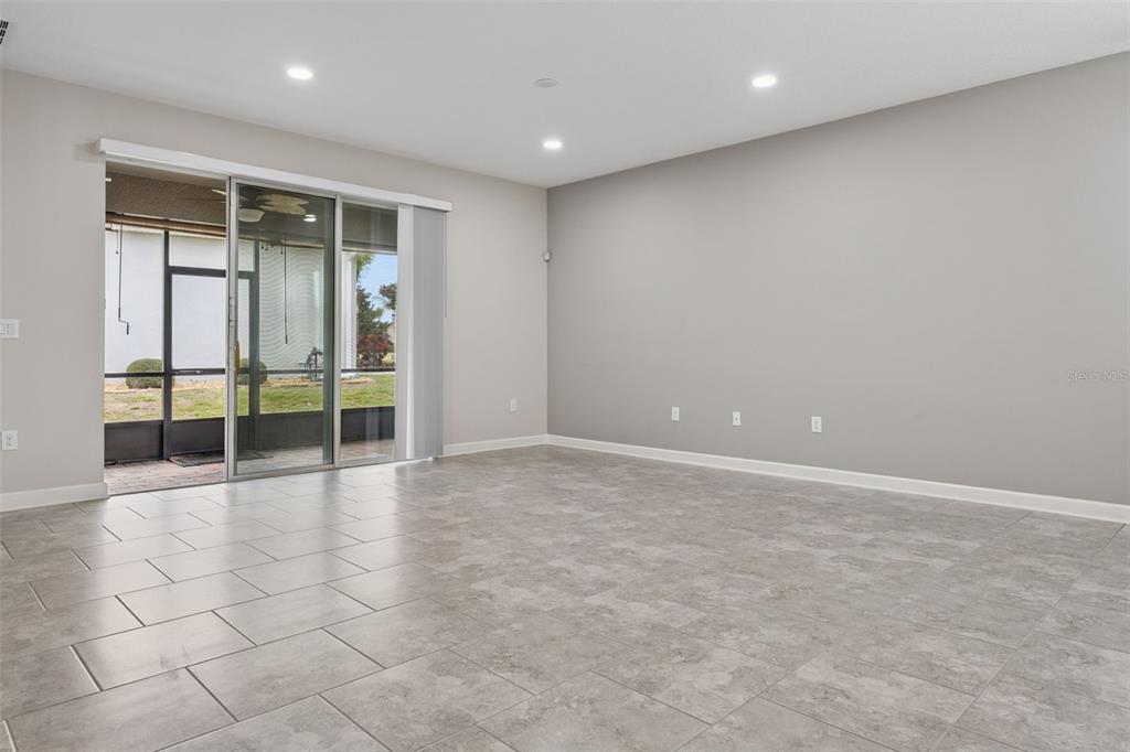 A kitchen with white cabinets, granite countertops, stainless steel appliances, and a tiled backsplash — 3464 EMBERS LANE, CLERMONT, FL