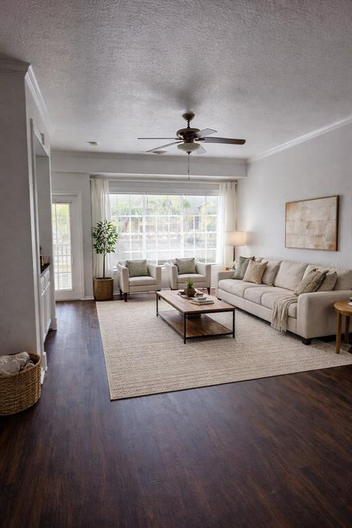 A living room features dark wood flooring, a beige sofa, two armchairs, and a ceiling fan — 2648 ROBERT TRENT JONES DRIVE UNIT 227, ORLANDO, FL