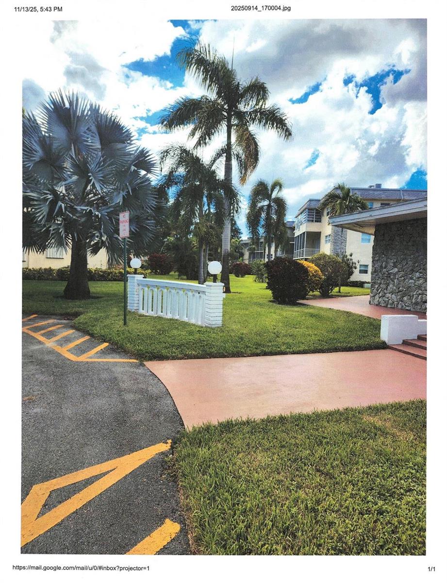 An exterior view of a residential building with palm trees, a lawn, and paved walkways — 4411 NW 16, Lauderhill FL 33313, LAUDERHILL, FL