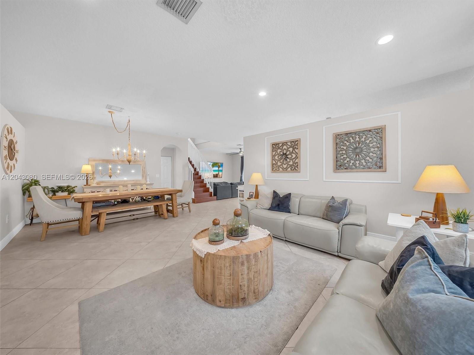 A living and dining area features light tile floors, a wooden coffee table, and neutral furniture — 4907 SW 166th Ave, Miramar FL 33027, MIRAMAR, FL