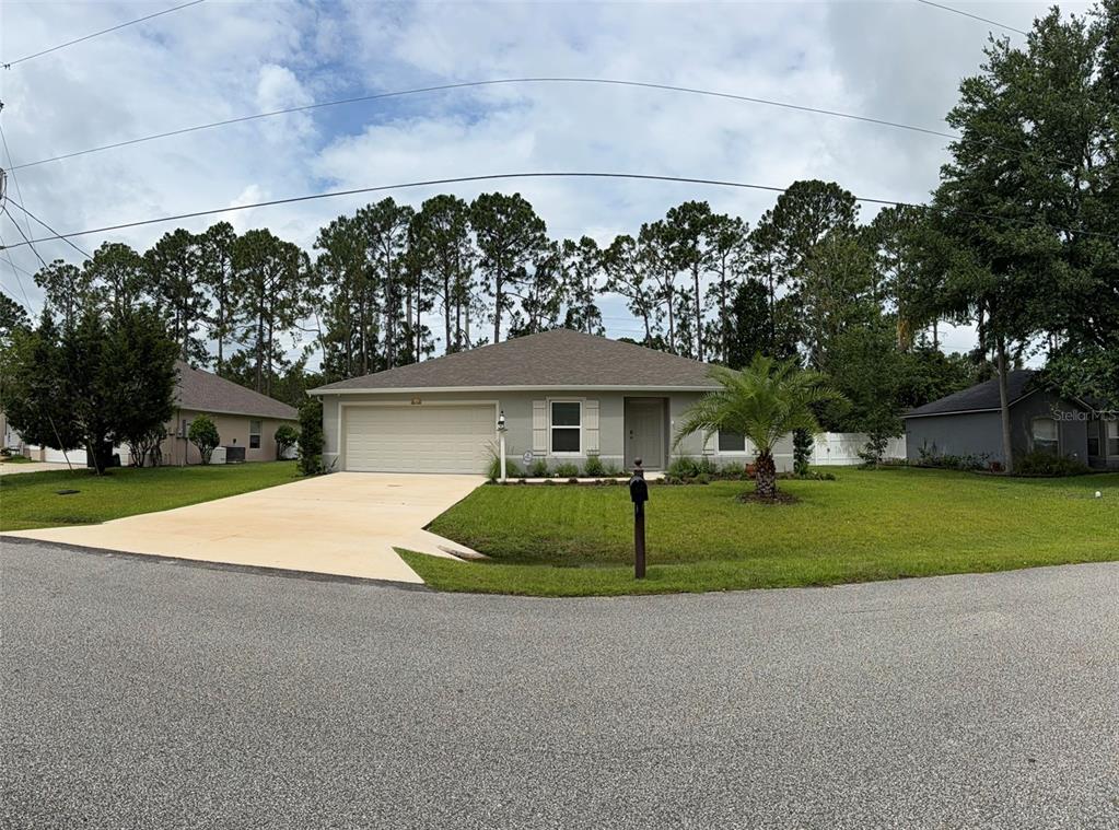A single-story house with a beige exterior, a two-car garage, and a front lawn — 177 UNDERWOOD TRAIL, PALM COAST, FL